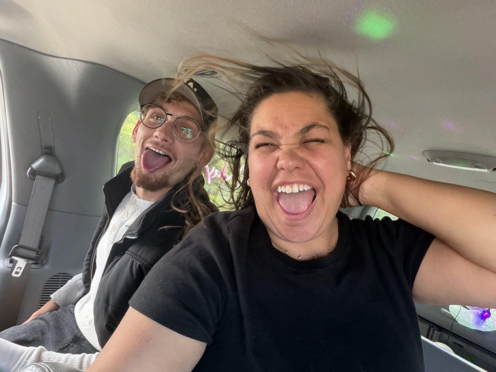 Friends laughing and singing along inside the karaoke limo in Nashville with party lights on the ceiling